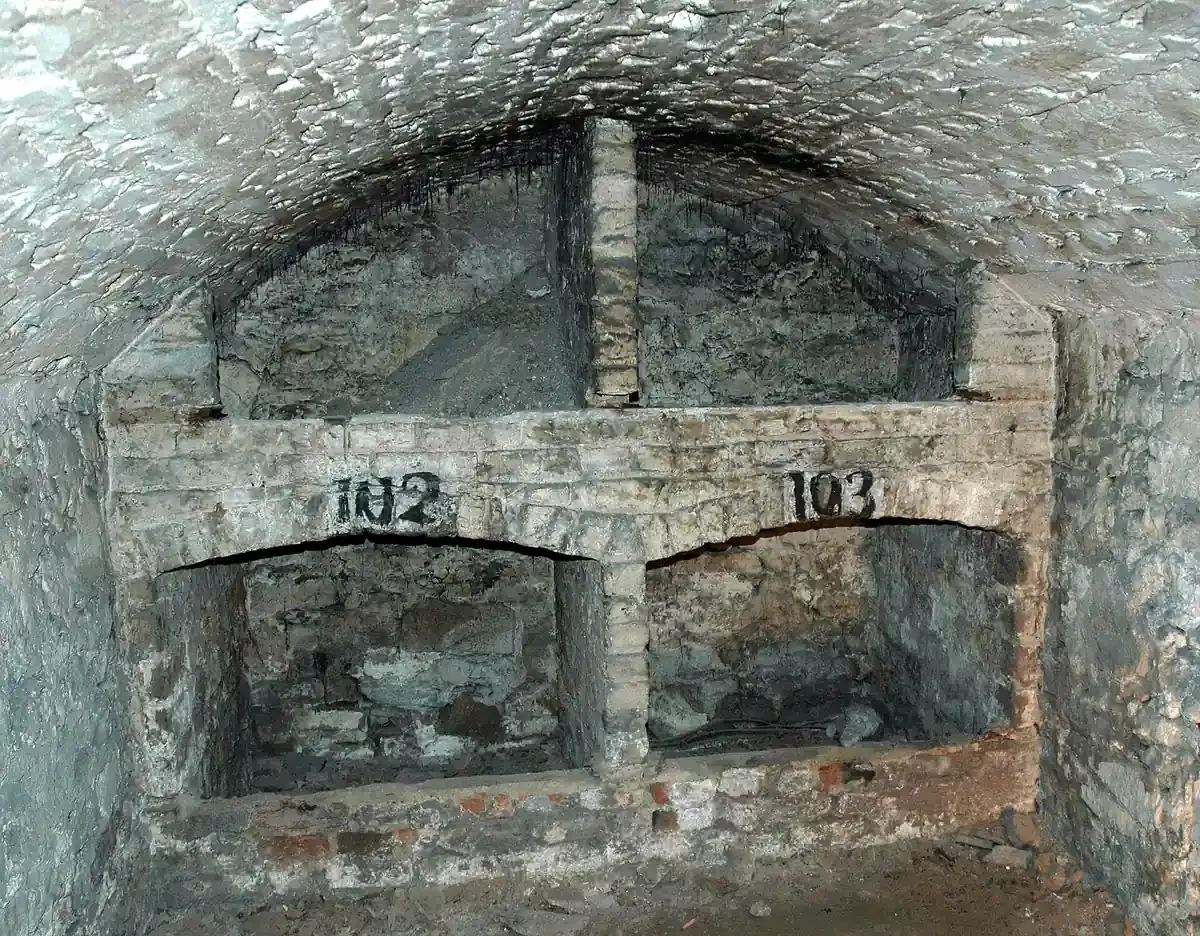 A vaulted stone chamber with storage niches in the Edinburgh Vaults under the South Bridge
