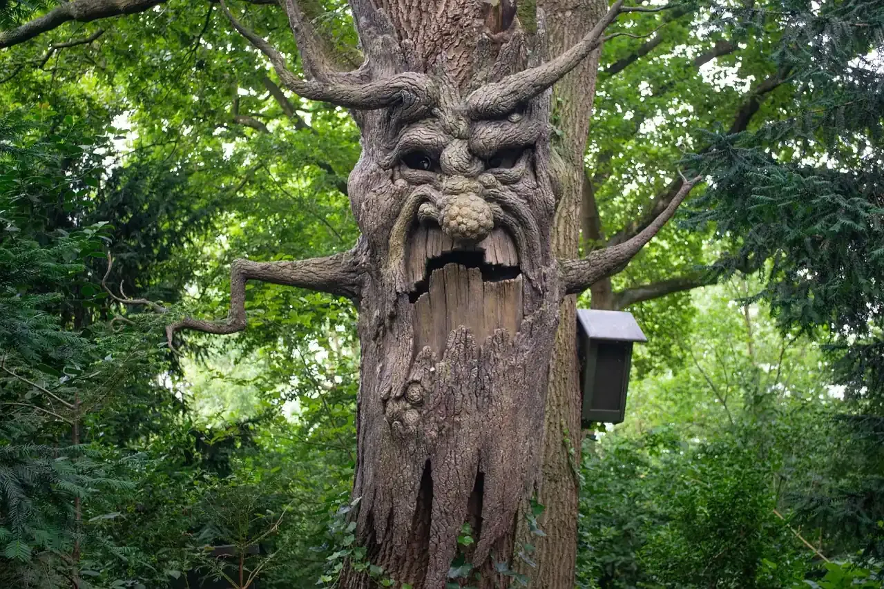 A carved fairytale tree standing among woodland in the Fairytale Forest at Efteling