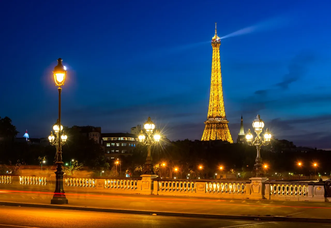 Eiffel Tower illuminated from the Alexandre III Bridge