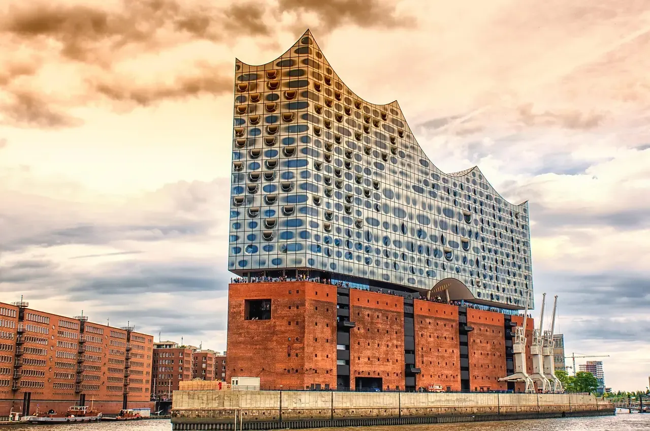 The glass wave of the Elbphilharmonie above its brick warehouse base in Hamburg