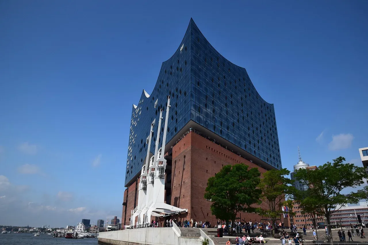 The Elbphilharmonie rising from its brick base seen from the quay entrance in Hamburg