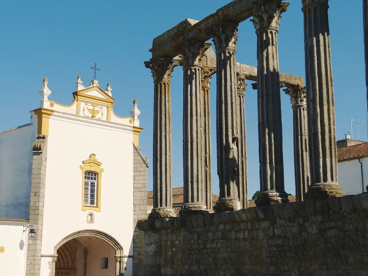 The Roman temple of Evora beside the whitewashed church of the Loios
