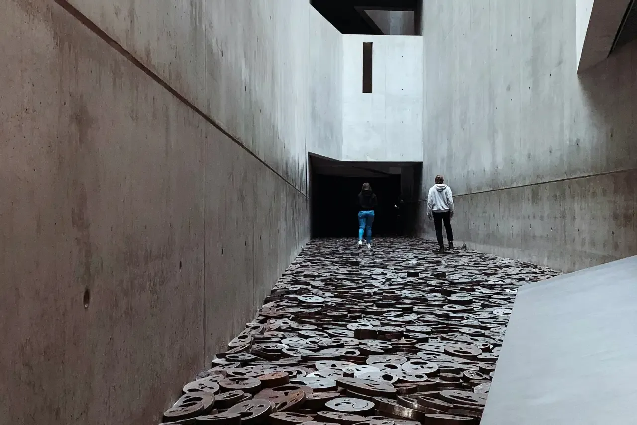 Visitors walking through the 'Fallen Leaves' installation