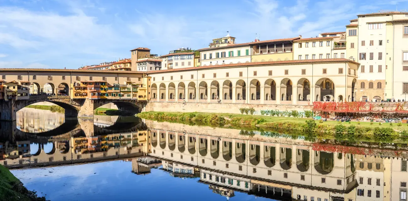 The Vasari Corridor and Ponte Vecchio over the Arno River in Florence at sunrise