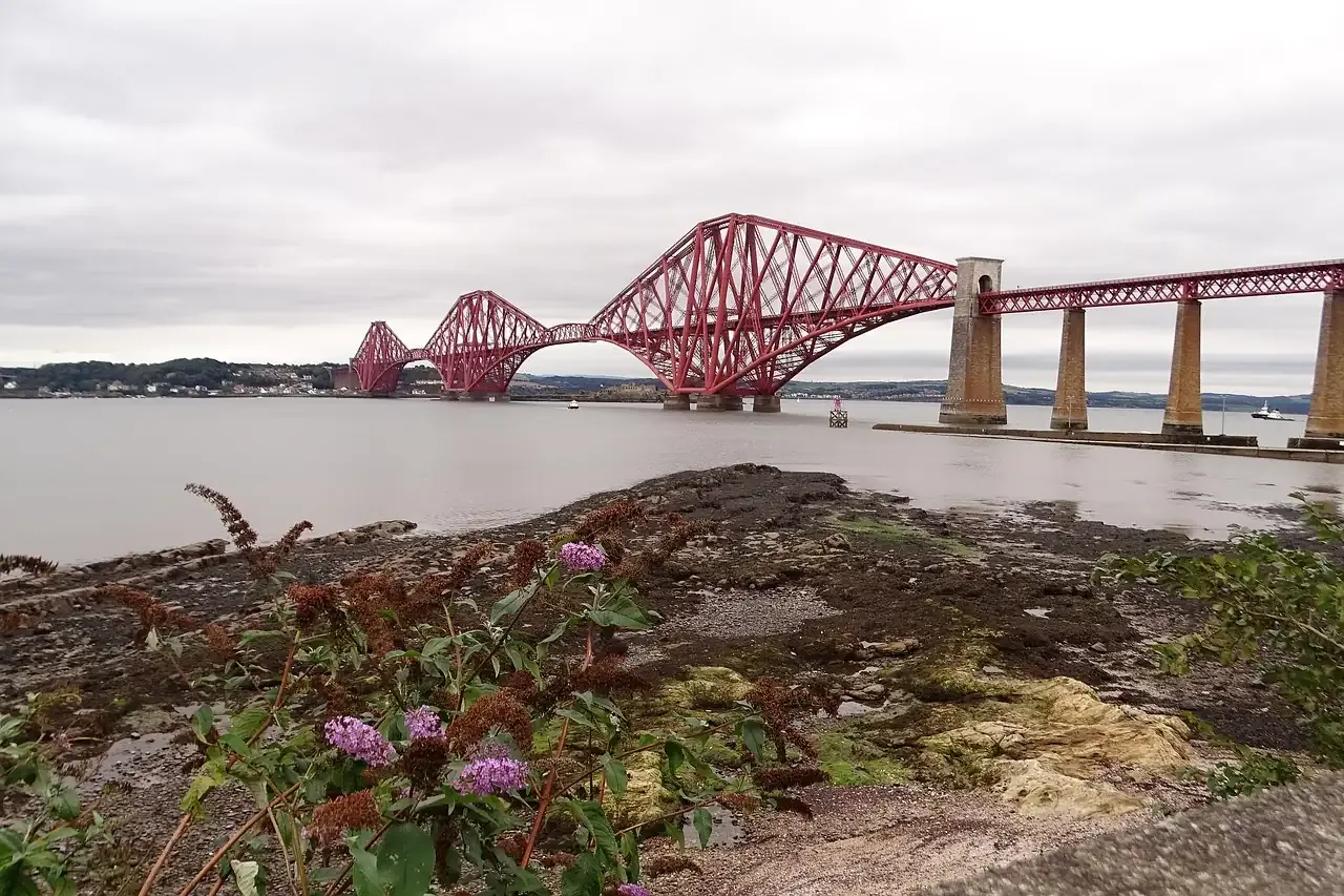 The red cantilever spans of the Forth Bridge over the Firth of Forth in Scotland