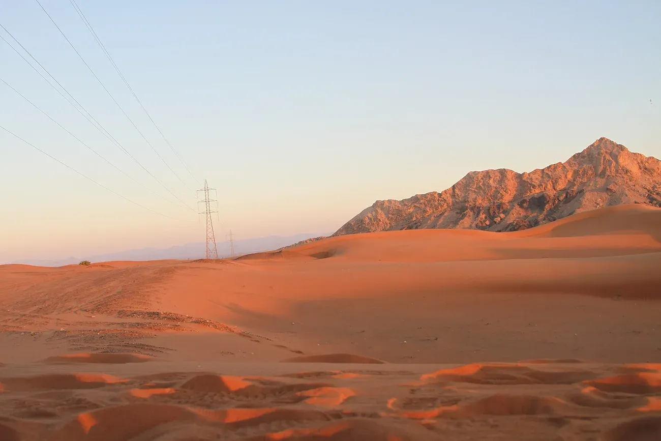 Fossil Rock rising over the dunes near Mleiha in the emirate of Sharjah