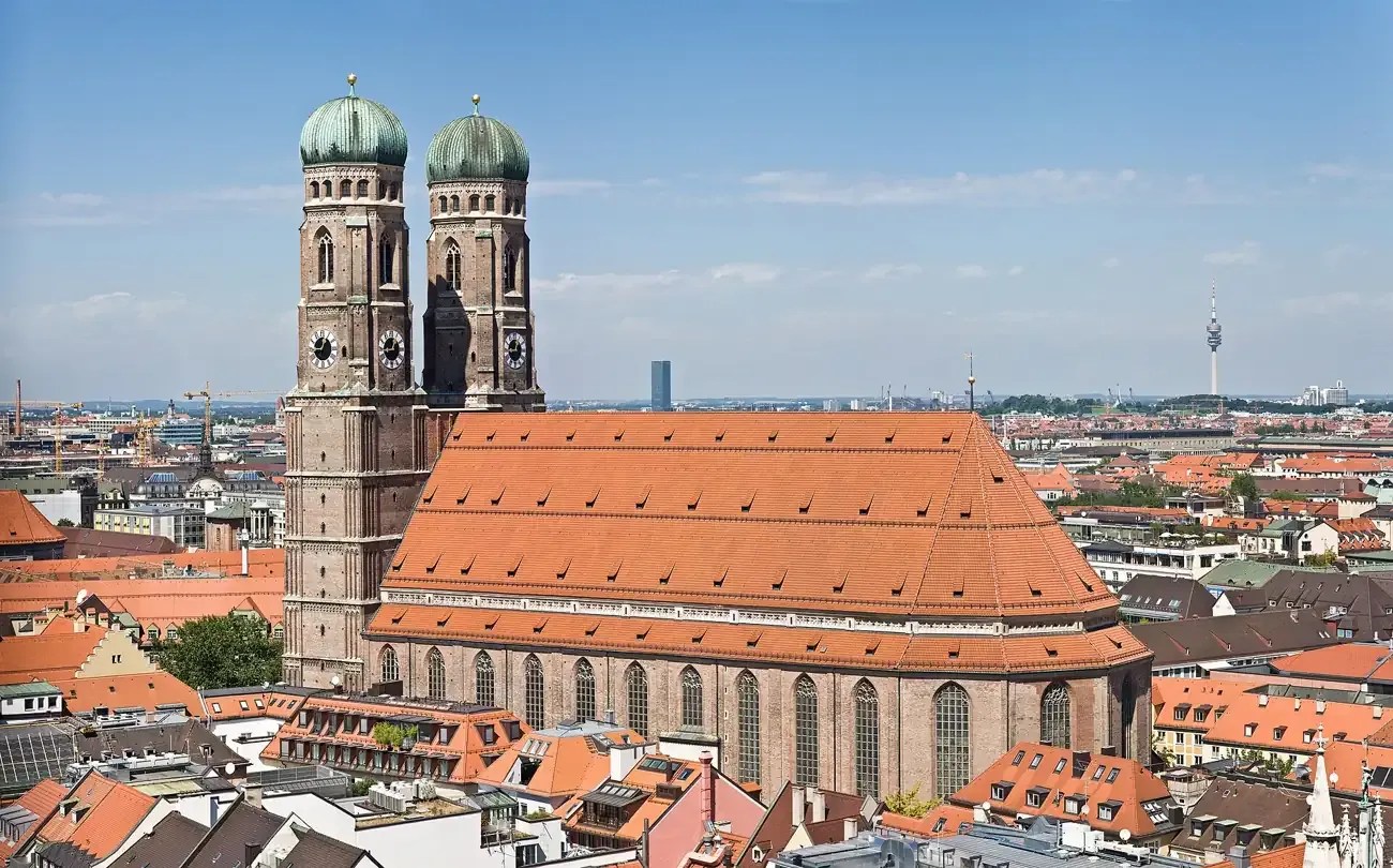 The twin onion-domed towers of the Frauenkirche rising above the old town rooftops of Munich