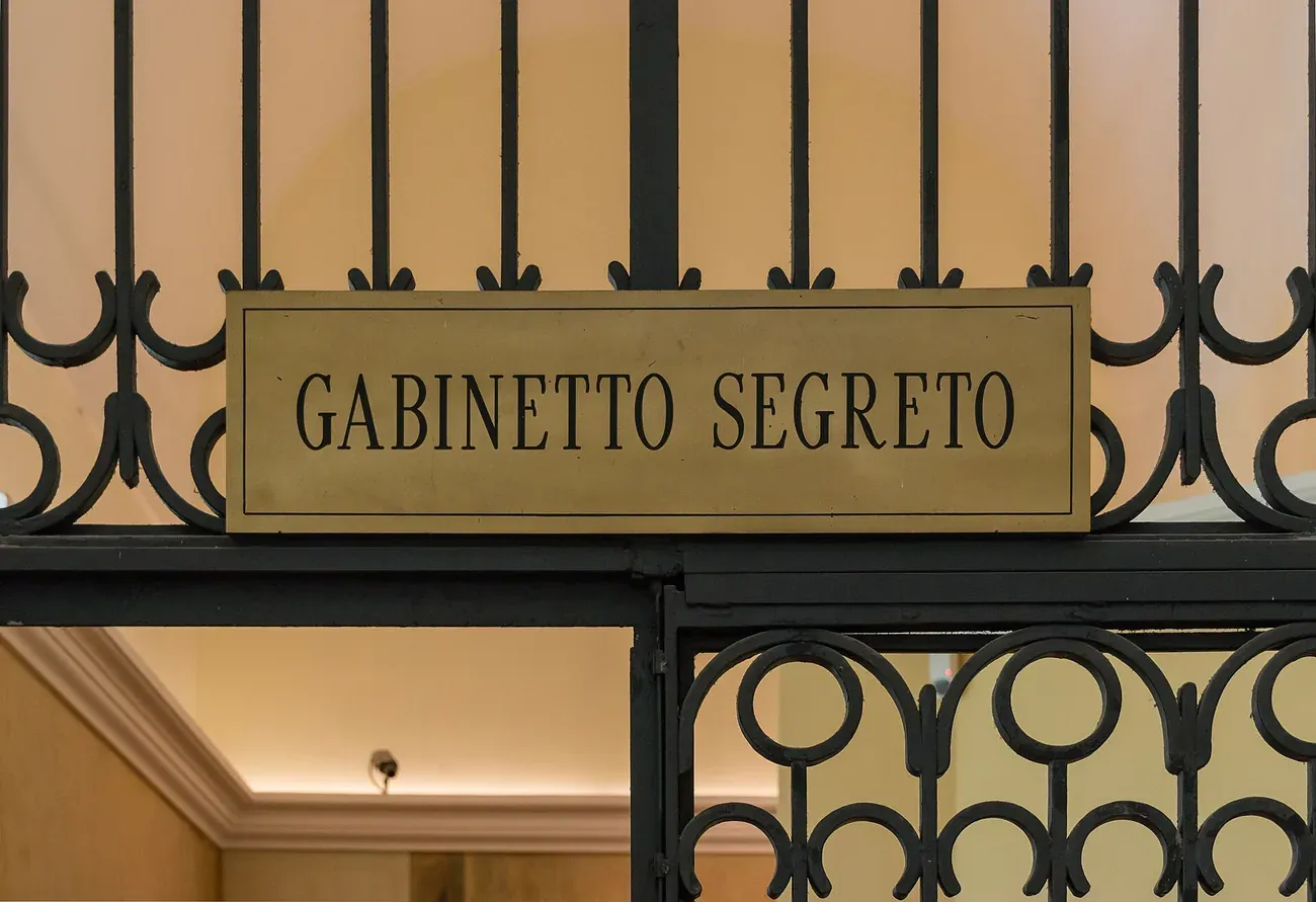The Gabinetto Segreto brass sign above the wrought-iron gate at the entrance to the Secret Cabinet in the National Archaeological Museum of Naples