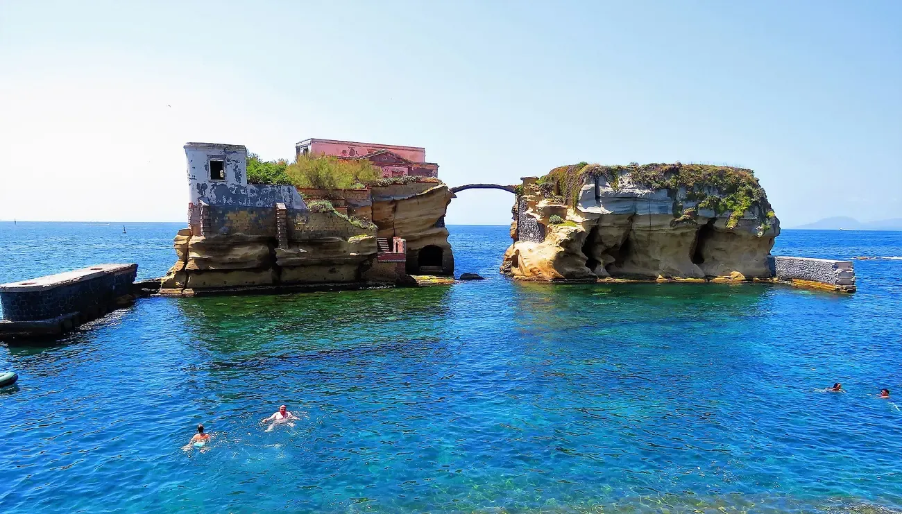 The twin rock islets of Gaiola joined by a slender arch off the Posillipo coast in Naples