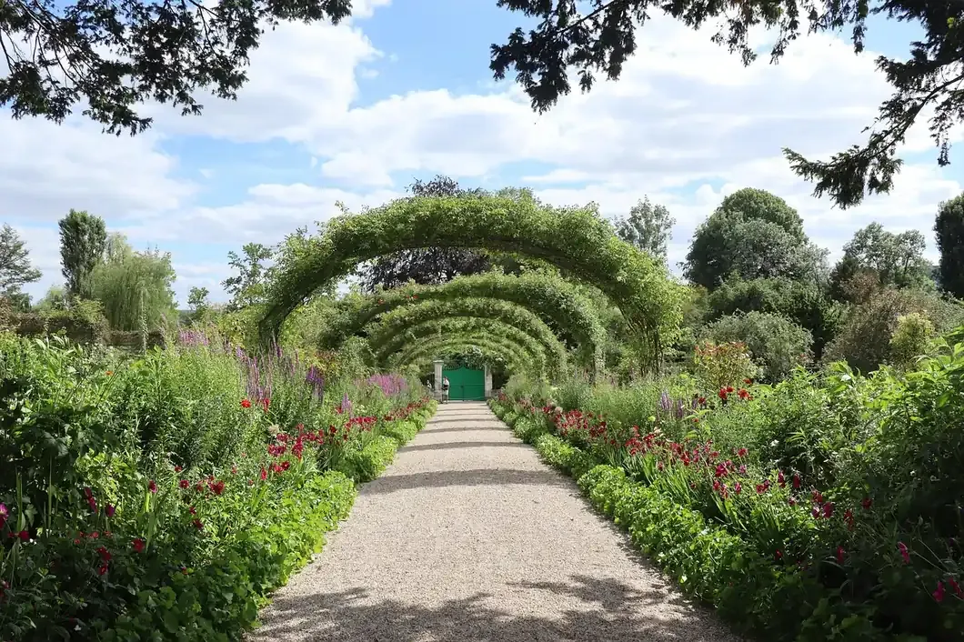 The Grande Allee of rose arches leading to Claude Monet's house at Giverny in Normandy