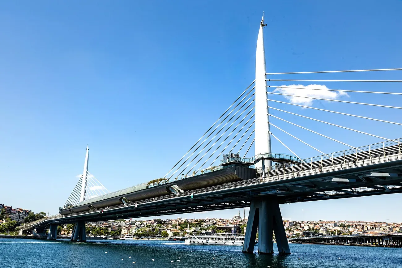 The cable-stayed Golden Horn Metro Bridge with its white pylons and the station in mid span over the Golden Horn, Istanbul