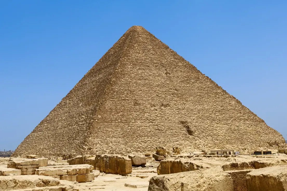 The Great Pyramid of Khufu rising above tumbled stone blocks at its base, Giza.