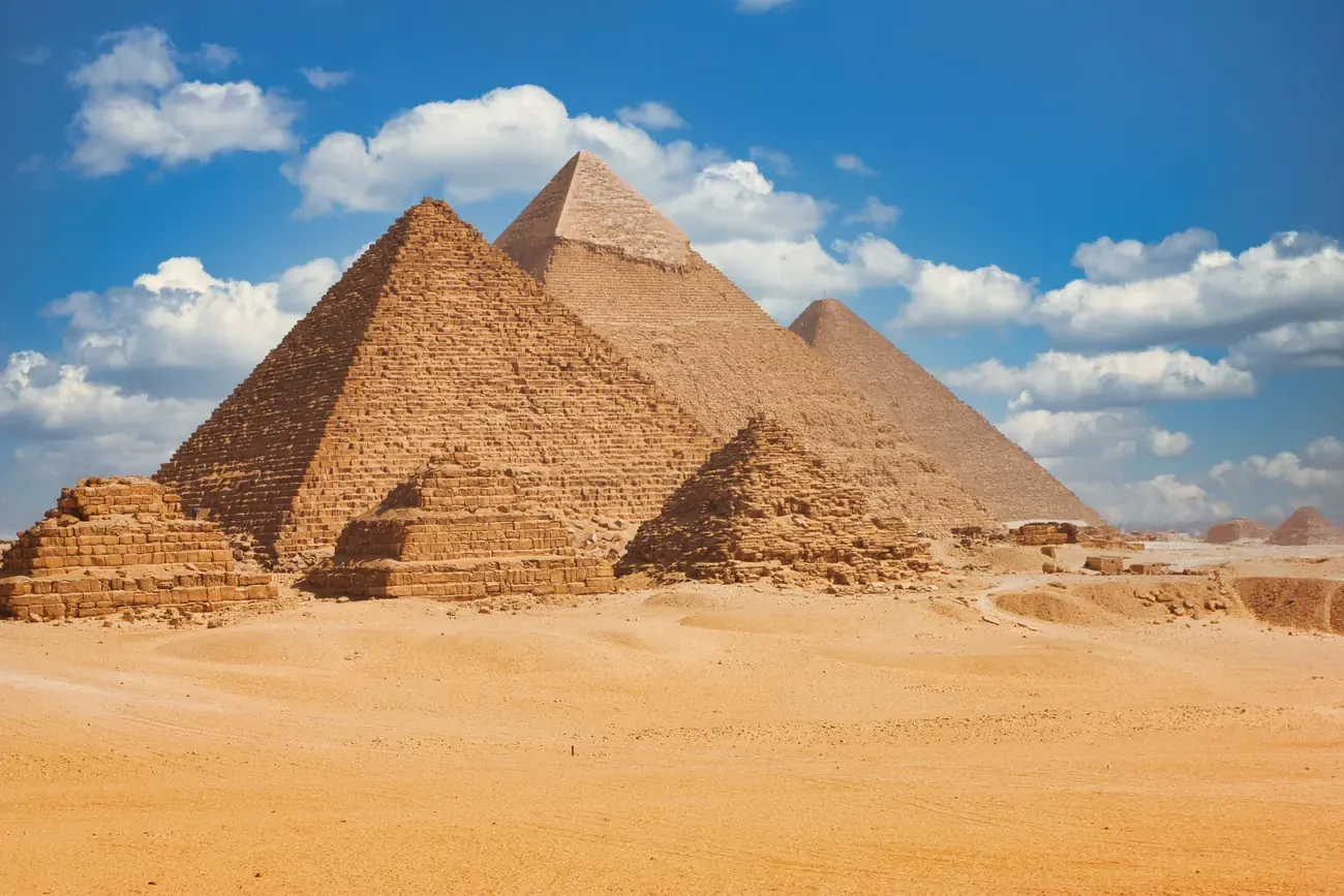 The three Great Pyramids of Giza under a blue sky near Cairo