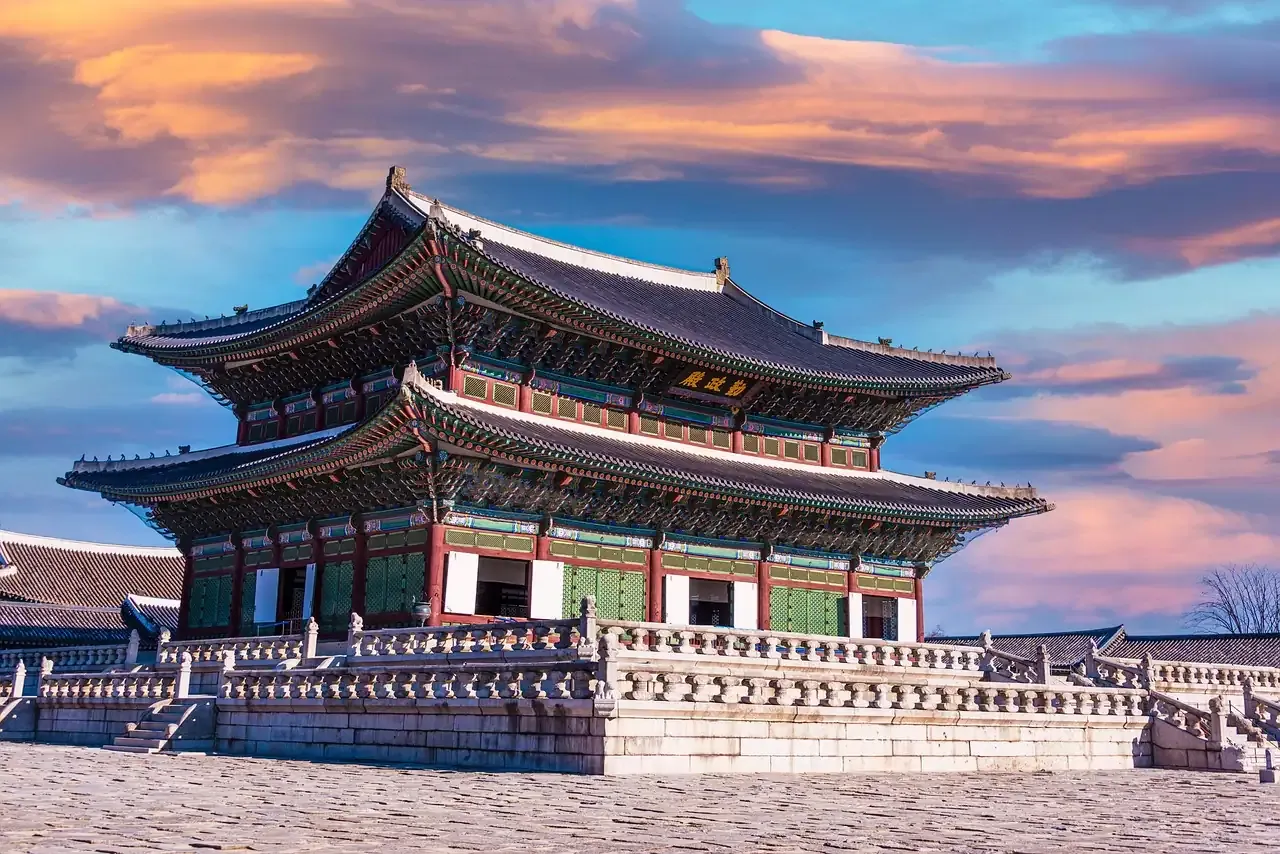 The Geunjeongjeon throne hall of Gyeongbokgung Palace under an evening sky in Seoul