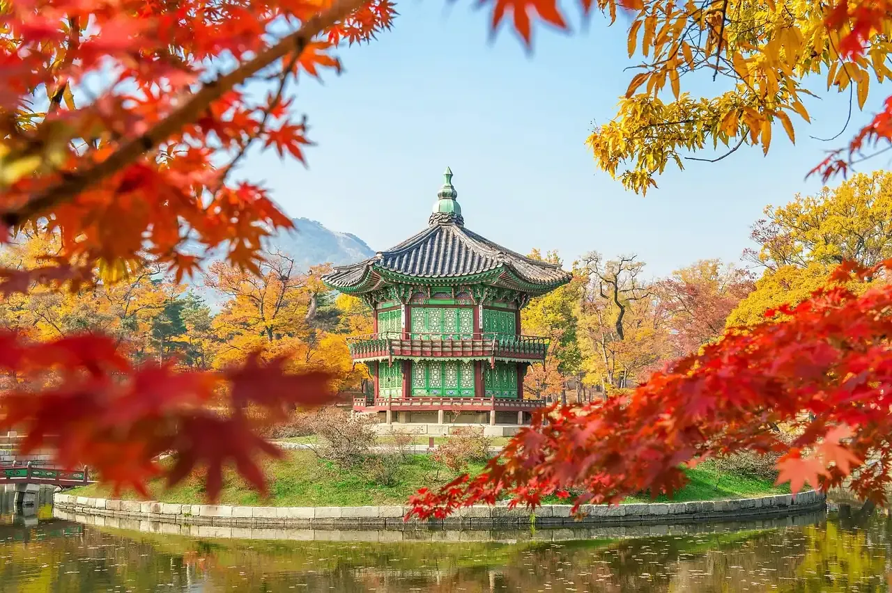 The Hyangwonjeong pavilion of Gyeongbokgung Palace among autumn leaves in Seoul