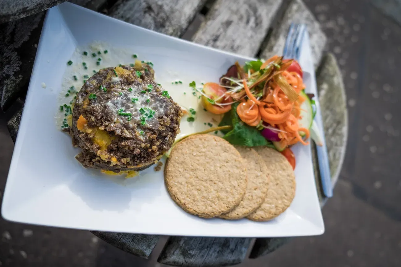 Haggis plated with oatcakes and garnish in Scotland