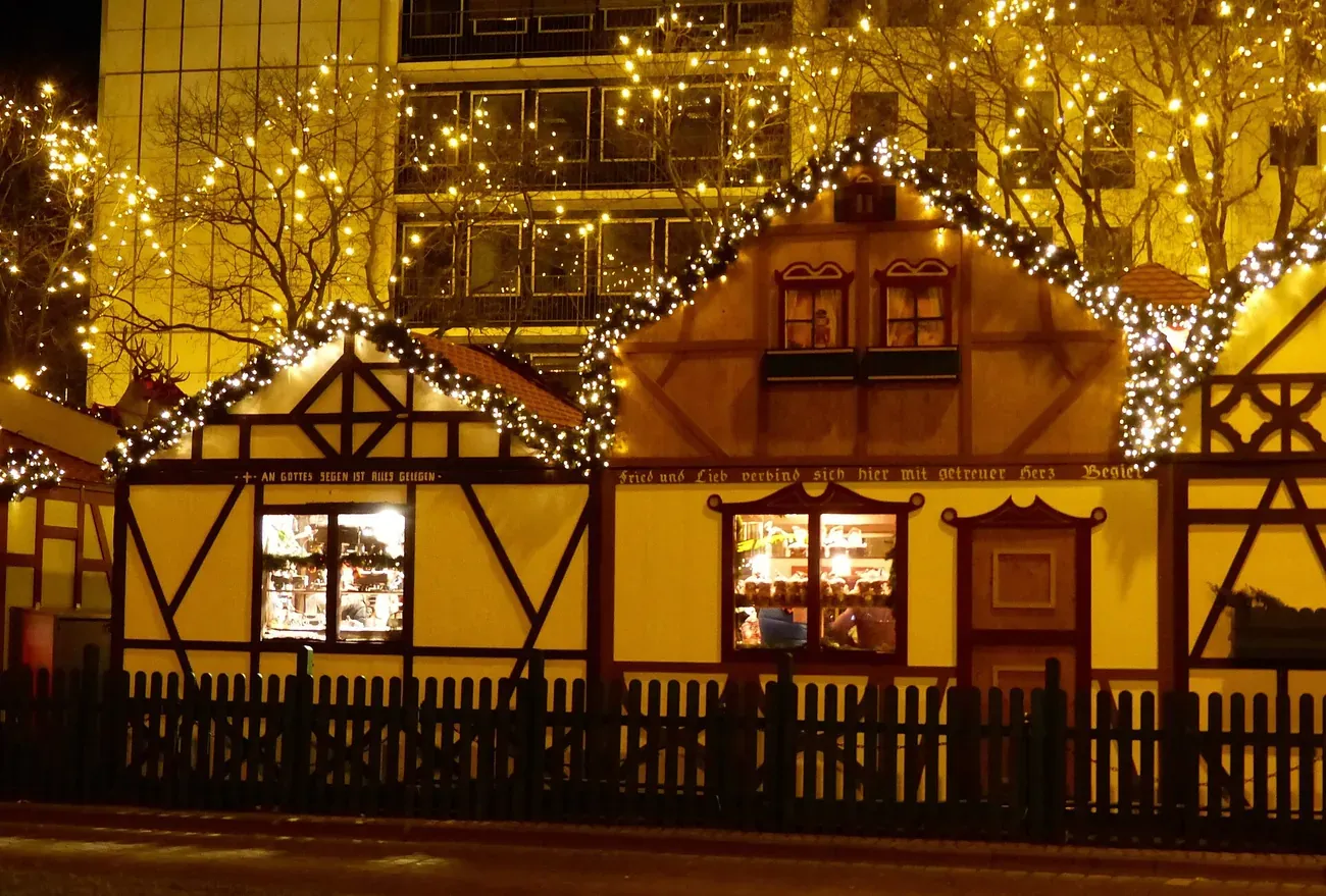 Lit half-timbered huts of the Christmas market on Rudolfplatz, Cologne