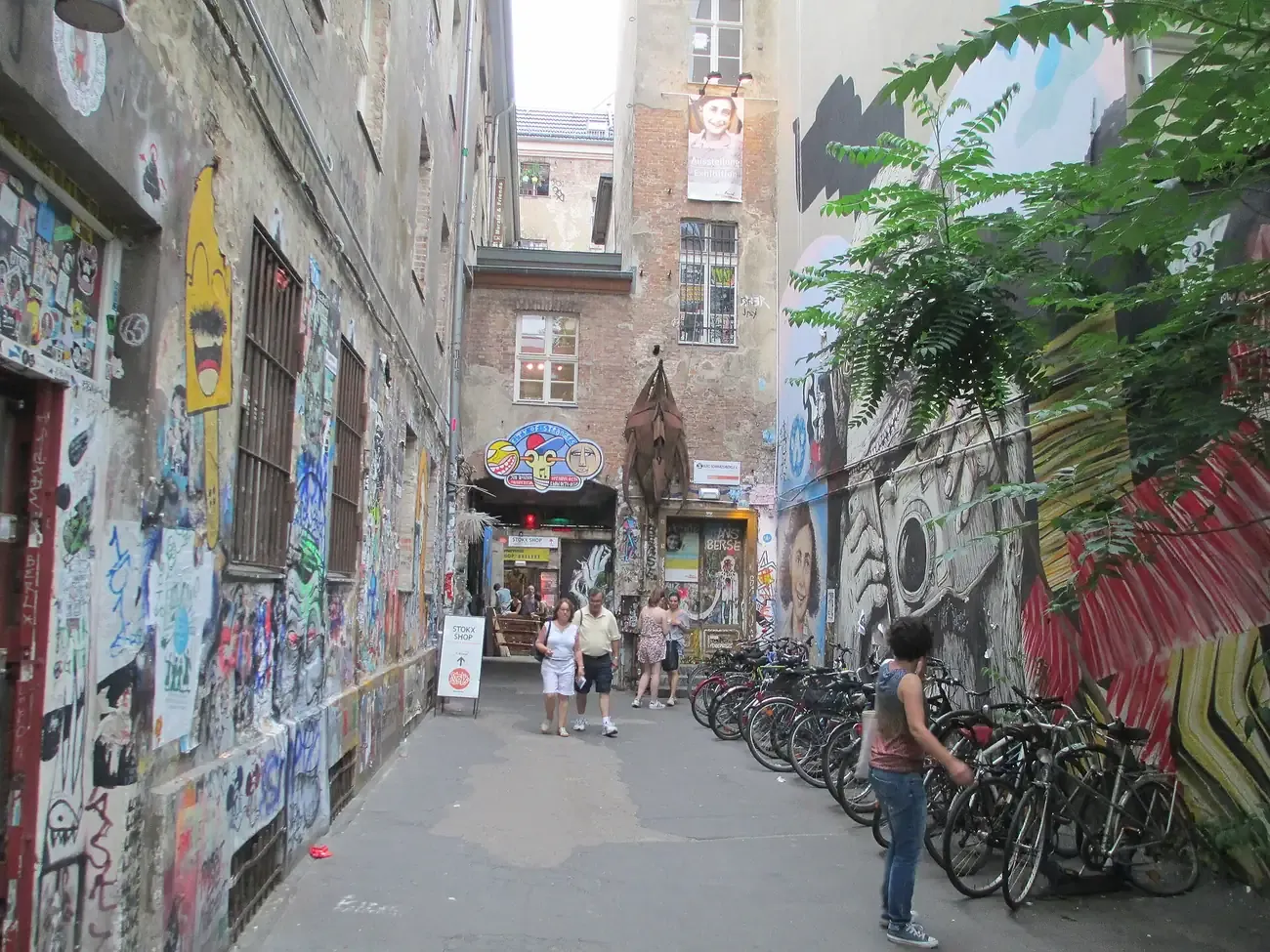 Layers of stickers, paste-ups and murals covering both walls of the Haus Schwarzenberg passage in Berlin