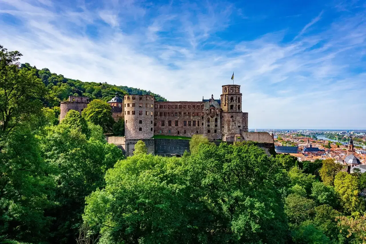 Heidelberg Castle on its wooded slope above the town under a blue sky