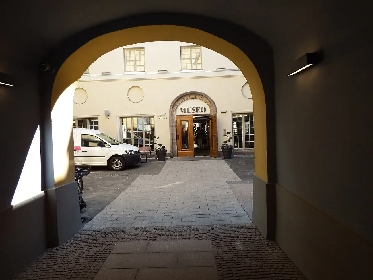 The courtyard entrance of the Helsinki City Museum seen through the Aleksanterinkatu gateway