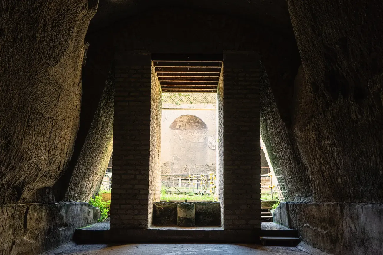 View through an ancient doorway across a sunlit courtyard at the Herculaneum excavations