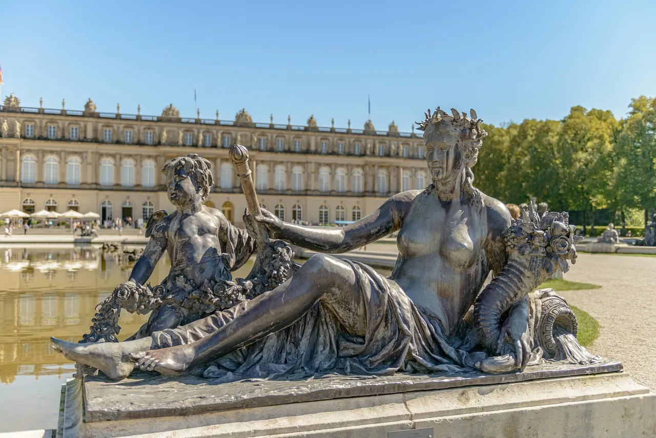 A garden statue in front of the New Palace of Herrenchiemsee on the Chiemsee