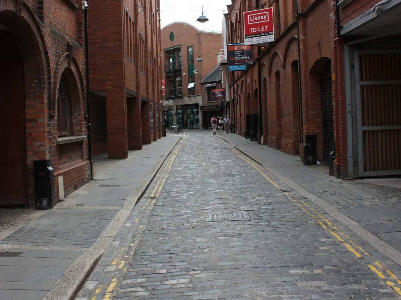 The cobbled Hill Street between red-brick buildings in the Cathedral Quarter of Belfast