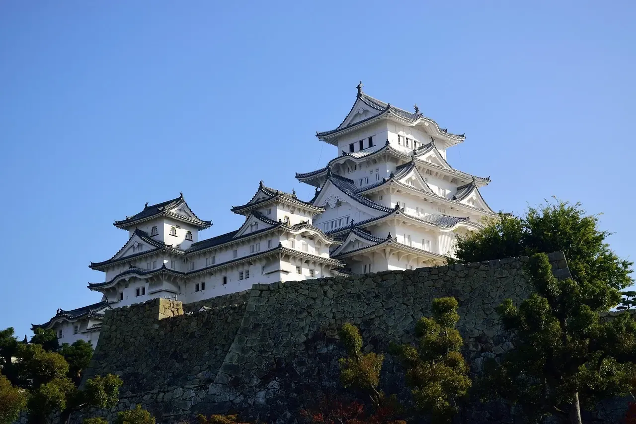 The white main keep of Himeji Castle above its curving stone base in Hyogo prefecture