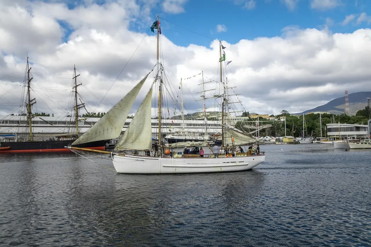 A tall ship on the Derwent below the hills at the Hobart waterfront in Tasmania