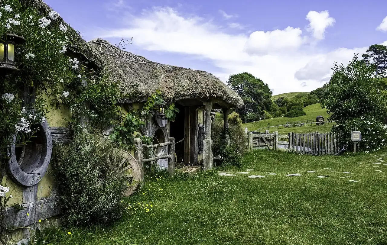 A hobbit hole with its round door and garden at the Hobbiton Movie Set near Matamata