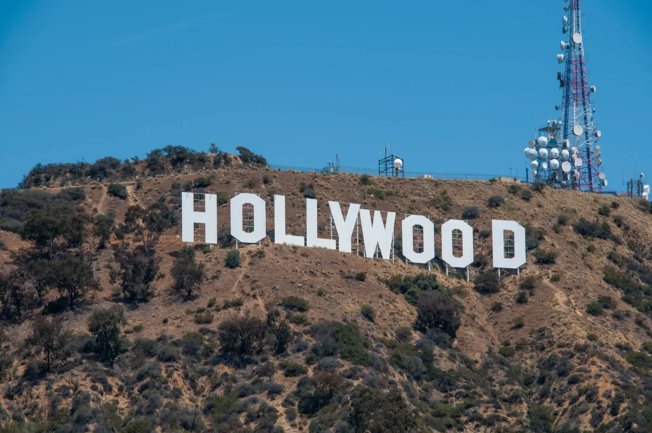The white letters of the Hollywood Sign seen across the hills in Los Angeles