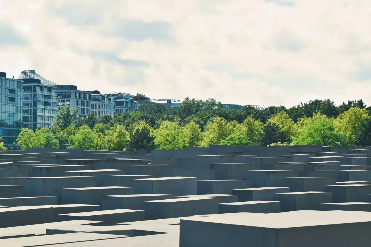 The Memorial to the Murdered Jews of Europe in Berlin with trees in the background