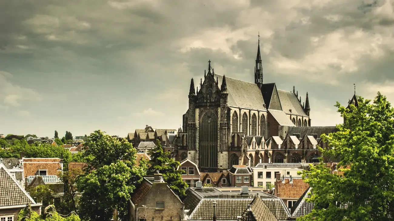 The Gothic Hooglandse Kerk rising above the rooftops of the old town in Leiden, Netherlands