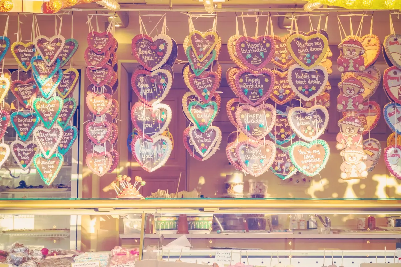 Rows of iced gingerbread hearts hanging at a stall at Hyde Park Winter Wonderland in London