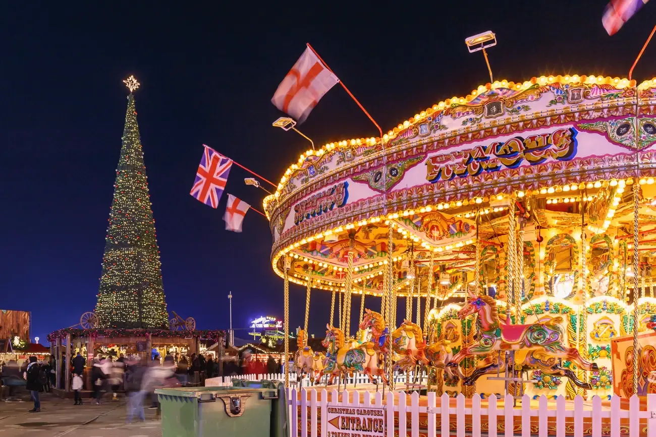 Vintage carousel with a Christmas tree and Union Jack flags at Hyde Park Winter Wonderland in London