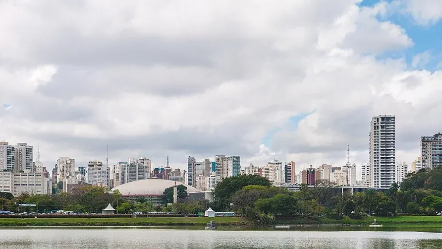 The lake of Ibirapuera Park with the towers of Sao Paulo behind it