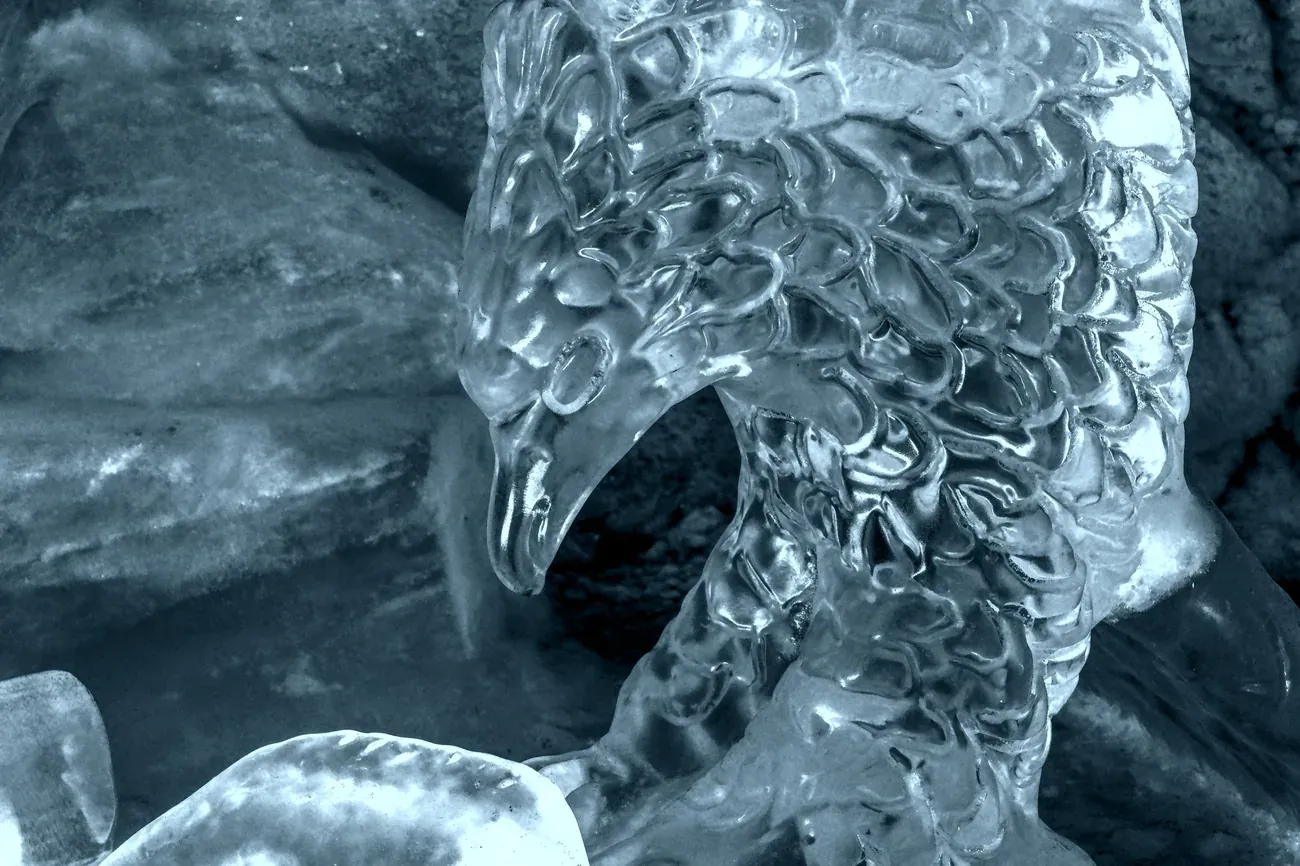 Close-up of a carved ice sculpture of a bird of prey head