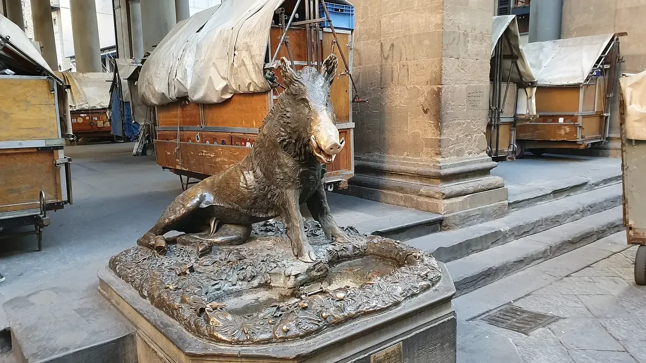 The bronze boar Il Porcellino with its polished snout in the Loggia del Mercato Nuovo in Florence