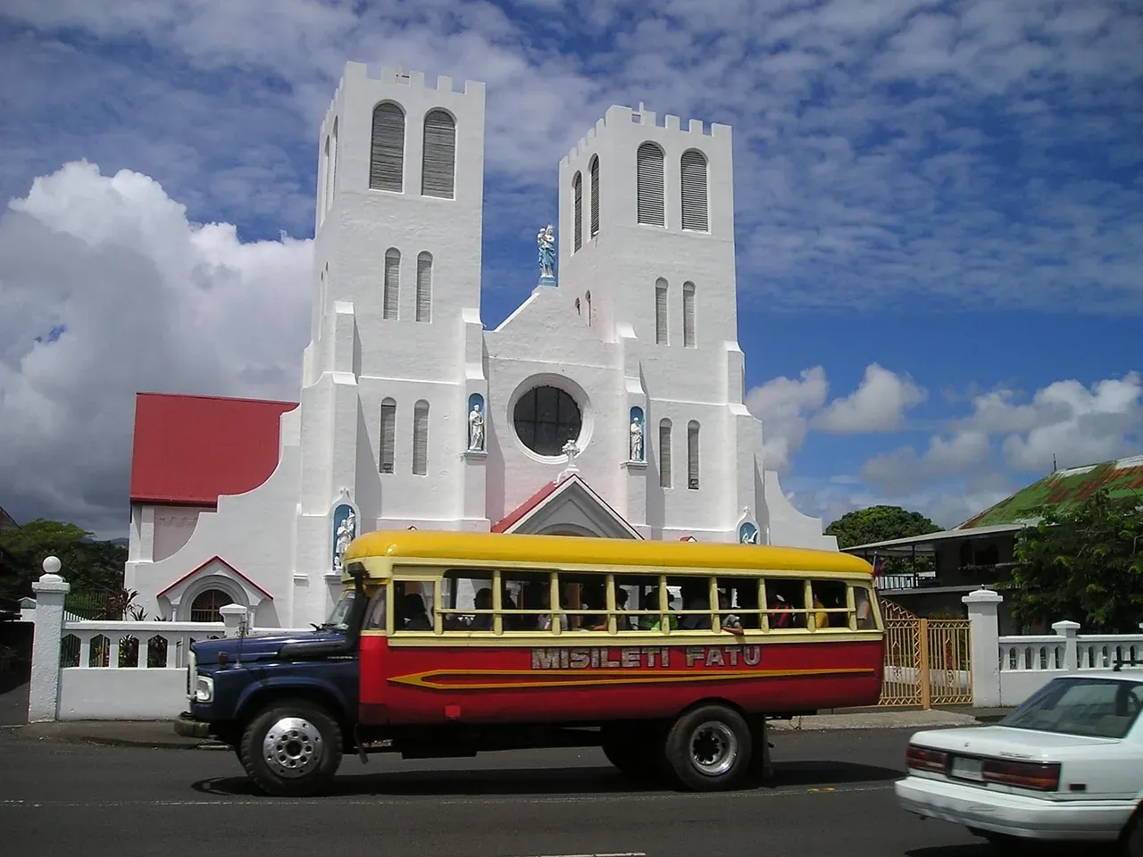 The Immaculate Conception Cathedral and a painted bus in Apia, Samoa