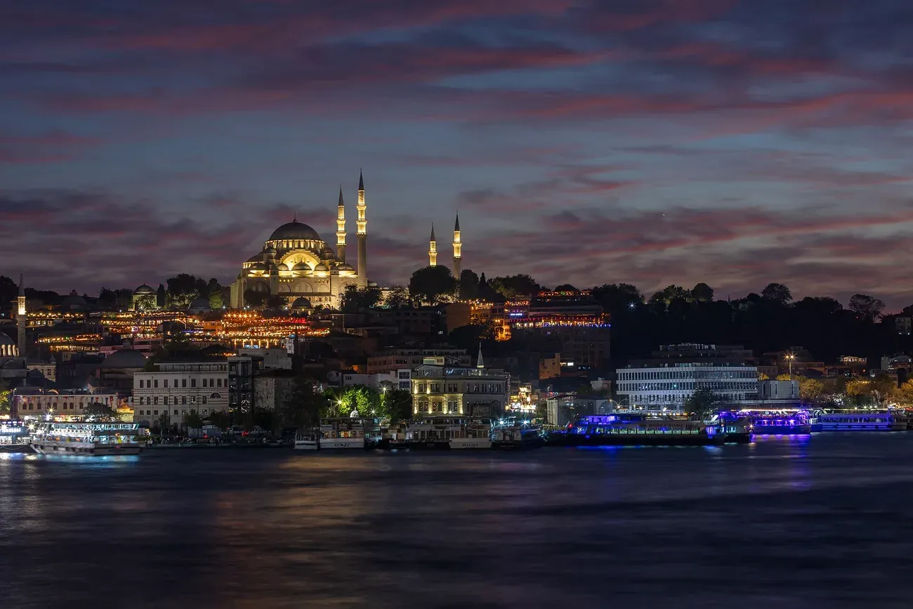 The Suleymaniye Mosque lit above the Golden Horn at dusk in Istanbul