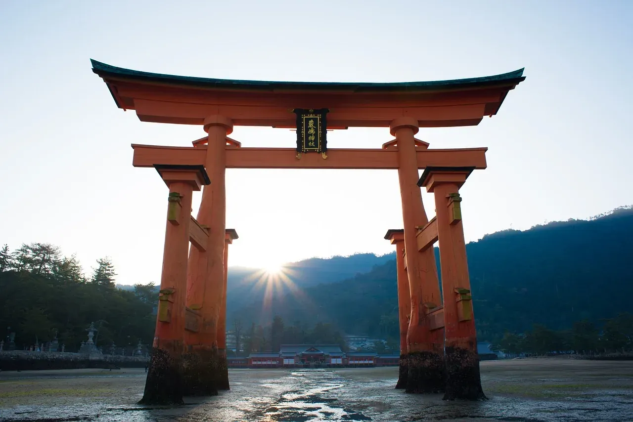 The great torii of Itsukushima Shrine backlit by the sun at Miyajima