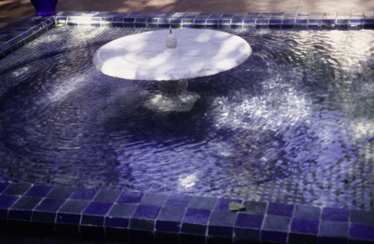 A cobalt-blue tiled fountain basin at the Jardin Majorelle in Marrakech