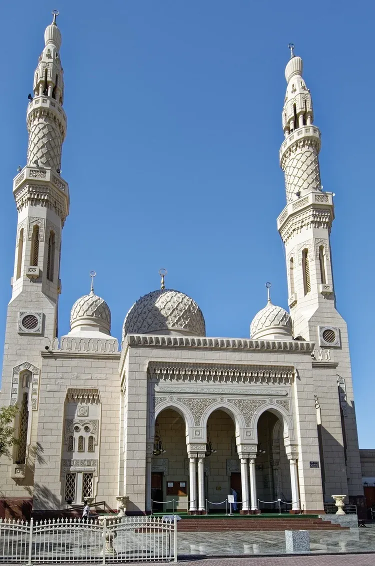 The twin minarets and carved facade of Jumeirah Mosque in Dubai