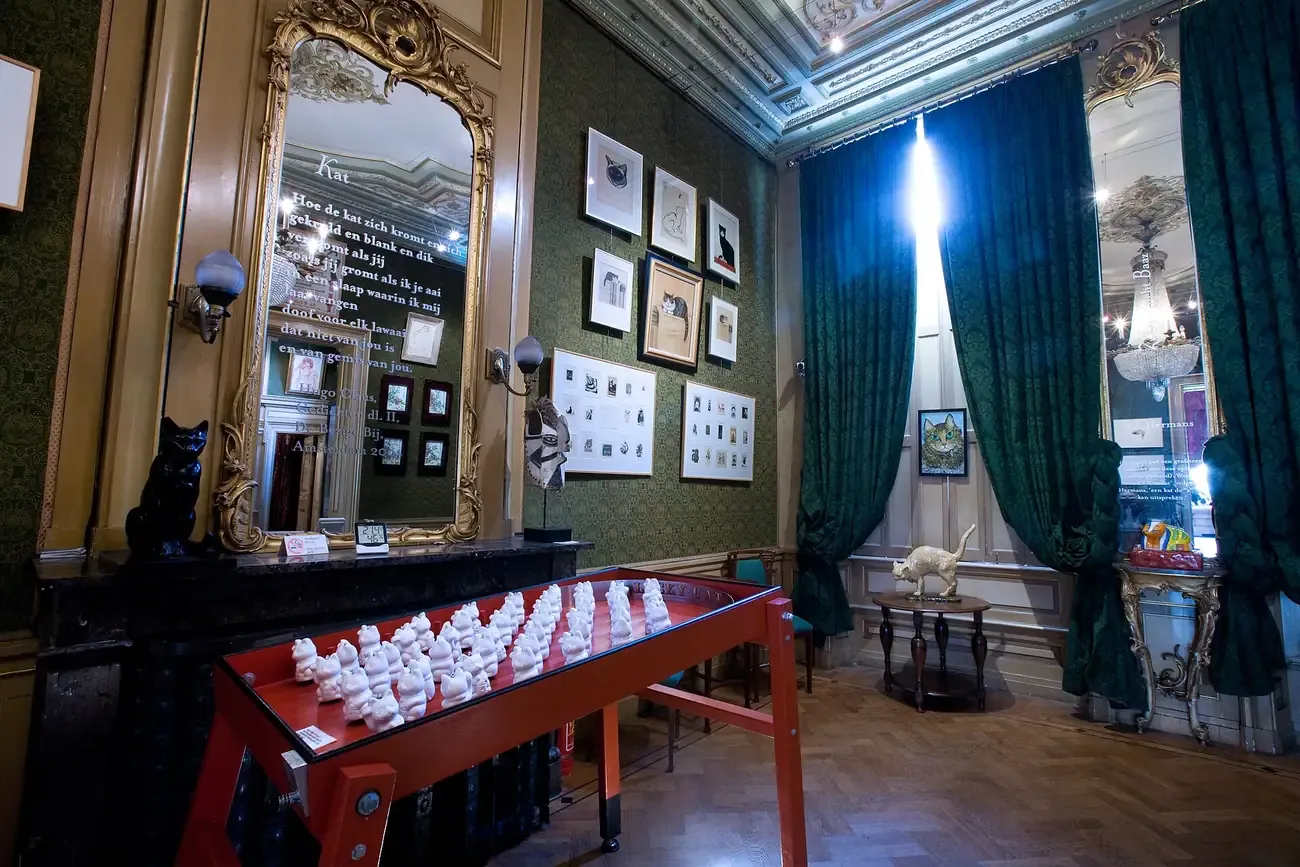 A room of the KattenKabinet cat art museum hung with paintings inside a Herengracht canal house in Amsterdam