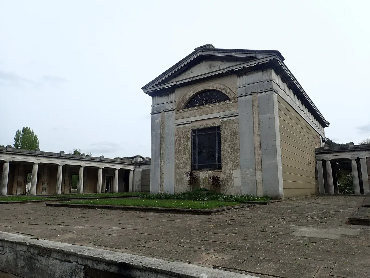The classical chapel at Kensal Green Cemetery flanked by Doric colonnades in London