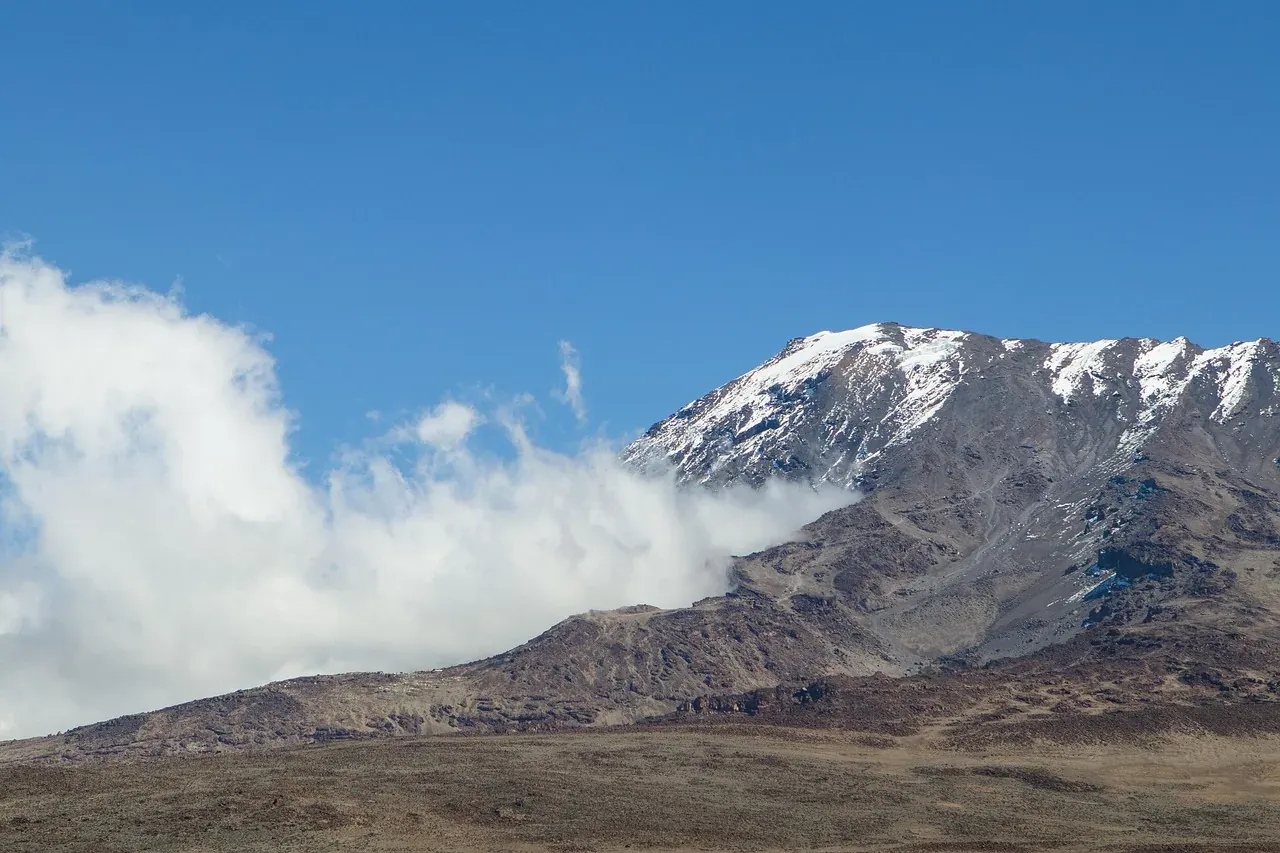 The summit glaciers of Kilimanjaro above the clouds in Tanzania