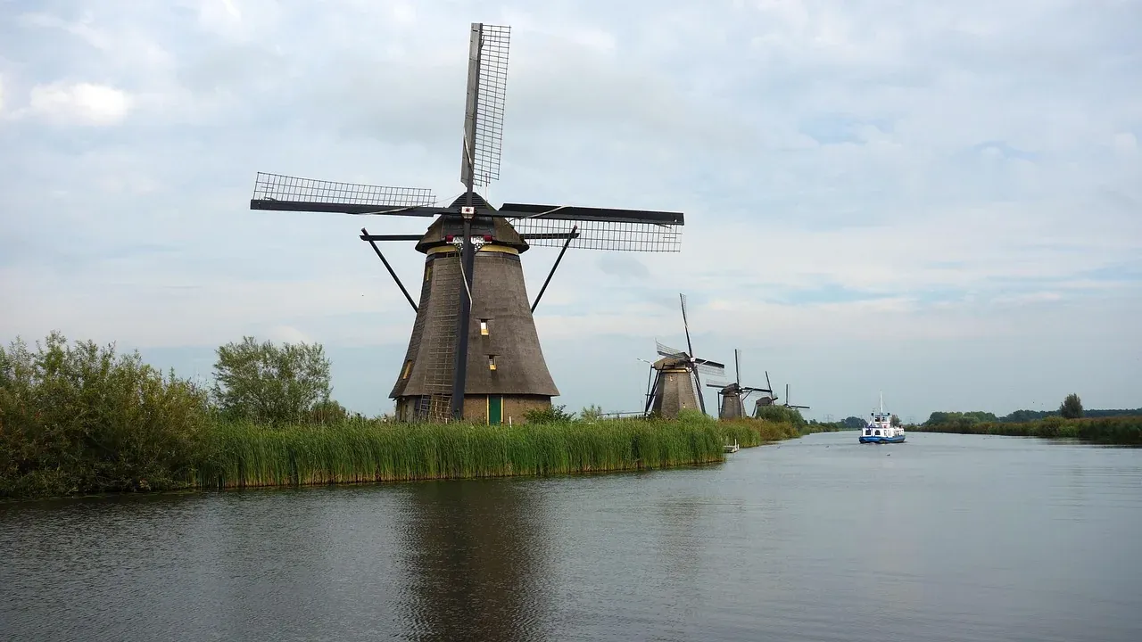 A row of thatched drainage windmills lining the canal at Kinderdijk in South Holland
