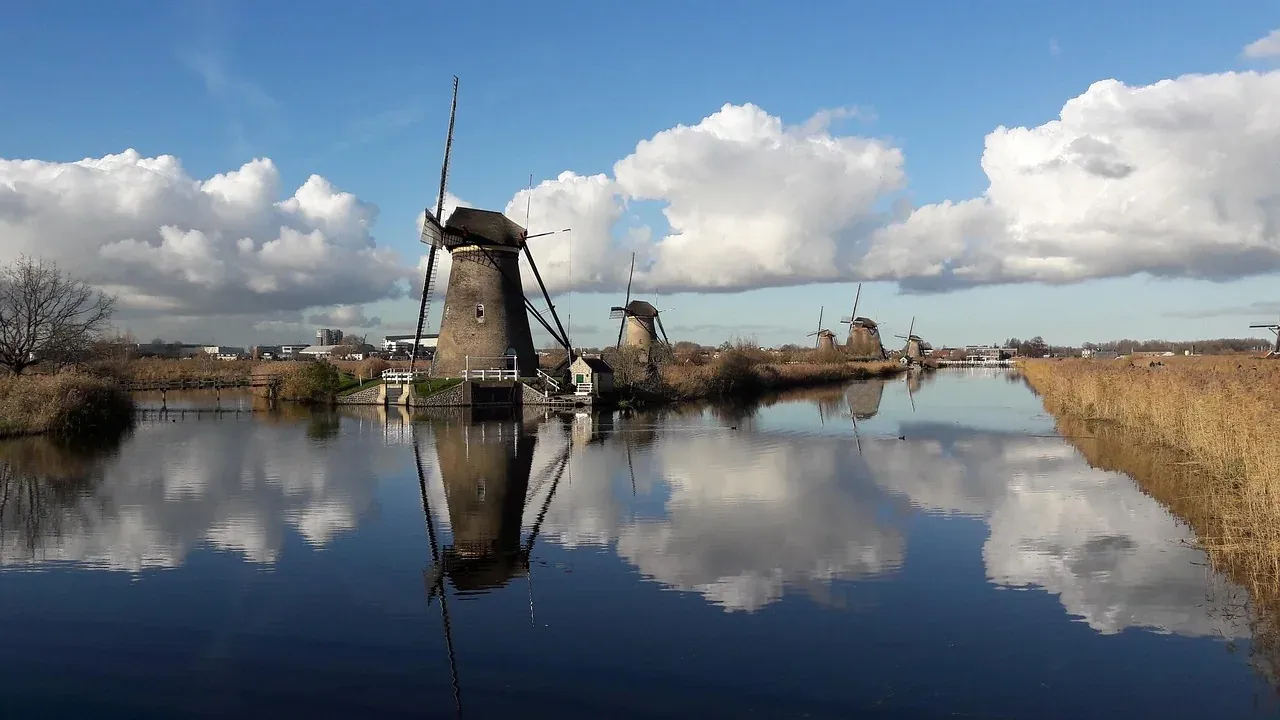 Kinderdijk windmills reflected in the still water of the Alblasserwaard polder canal