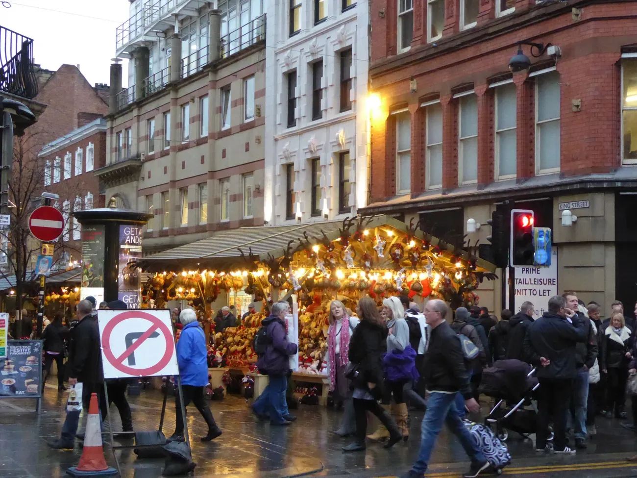 Christmas market chalets and shoppers on King Street, Manchester