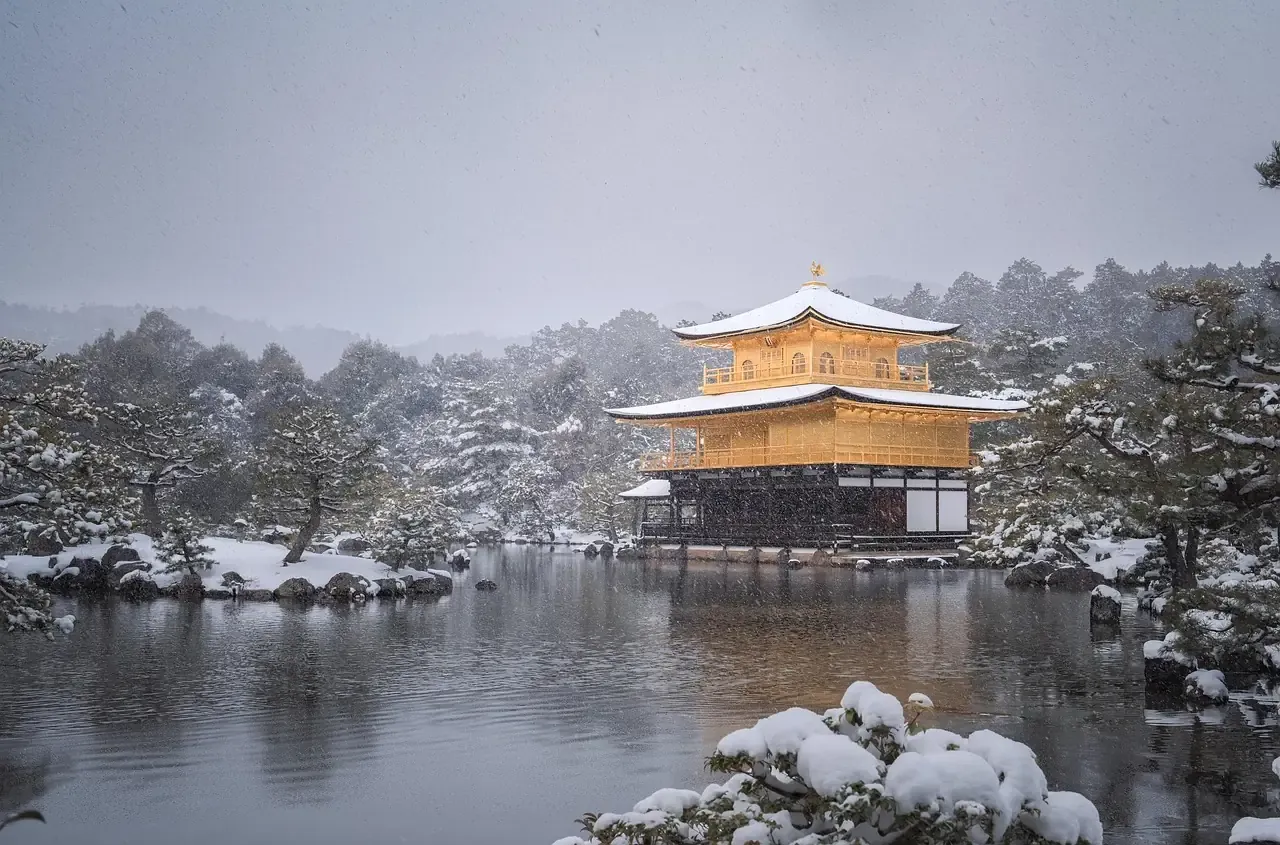 The Golden Pavilion of Kinkaku-ji under snow in Kyoto